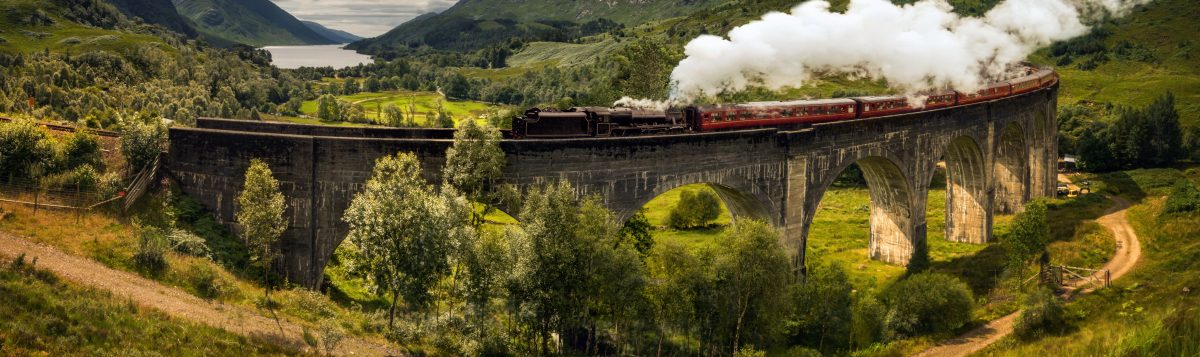 Forum of a stone bridge through which a train is passing